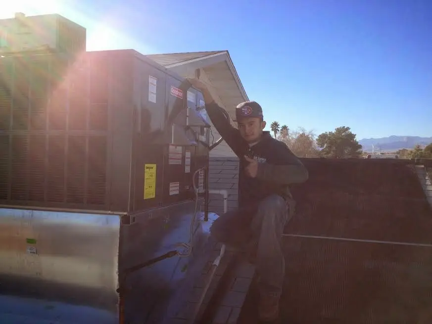 HVAC technician performing HVAC Inspection on a rooftop unit in Green